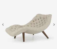 an upholstered chaise lounge chair with wooden legs