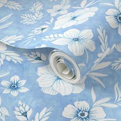 a blue floral wallpaper with white flowers on it