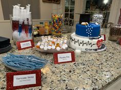 a table topped with lots of cakes and desserts