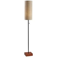 a lamp that is on top of a wooden base and has a light shade over it