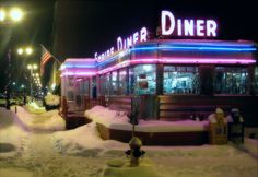 a diner is covered in snow at night