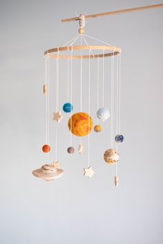 a mobile with planets and stars hanging from it