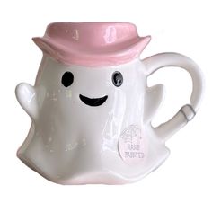 a white ceramic mug with a pink hat on it