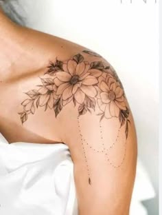 a woman's shoulder with flowers on it