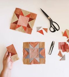 someone is cutting out small pieces of fabric to make a star quilt or wall hanging