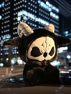 a black and white stuffed animal sitting on top of a car