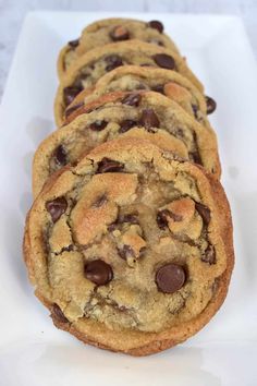 chocolate chip cookies are lined up on a white surface with the words brown butter chocolate chip cookies