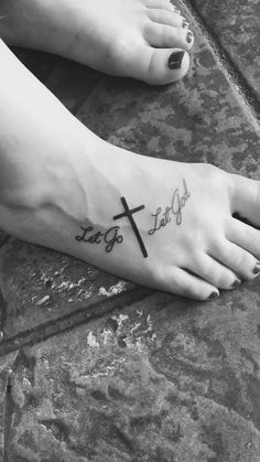 a woman's foot with a cross on it and the word faith written in cursive font