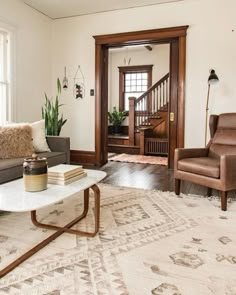 a living room filled with furniture and a rug