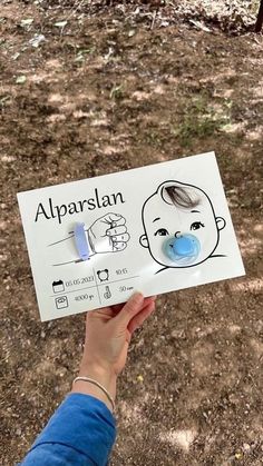 a person holding up a sign with an image of a baby's face