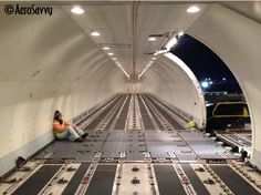 a woman sitting on the ground in a tunnel