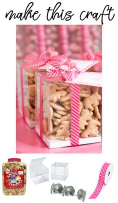 a pink table topped with boxes filled with cookies and crackers next to a ribbon