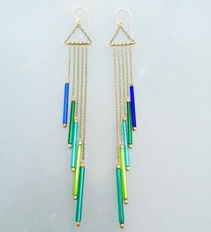 These earrings are inspired by the beautiful vintage bugle beads. The colors are amazing from the shades of blue and green. Brass chain, little African beads between the strands of chain. The ear wires are handmade, 14K gold filled, 20Ga, lever backs. The longest dangle is 110mm, the shortest is 60mm. I have more colors of these beads and the length can be adjusted if you like. ~Thank you for stopping by and supporting handmade, have a lovely day~ ~KR :) Tube Bead Earrings, Tube Bead Jewelry, Bugle Beads Earrings, Bugle Bead Jewelry, Bugle Bead Earrings, Beads Magic, Diy Earrings Easy, Beach Jewelry Boho, Beaded Chandelier Earrings