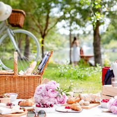 an outdoor picnic with wine, bread and flowers