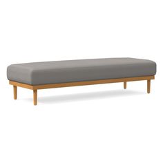 an image of a bench that is made out of wood and grey upholstered fabric