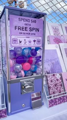 a purple and blue machine with lots of balls in it's display case on a table