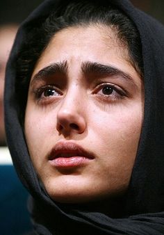 a close up of a person wearing a black hood