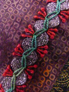 a close up of a bracelet on a cell phone