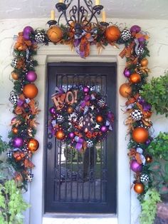 a front door decorated for halloween with decorations