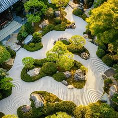 an aerial view of a garden with rocks and trees in the center, surrounded by gravel