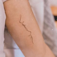 a woman's arm with a small tattoo on the left side of her arm