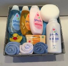 baby shower products in a basket on a counter top with blue towels and yellow rubber duck