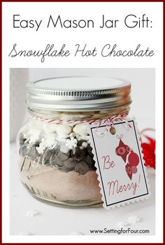 a mason jar filled with snowflake hot chocolate and marshmallows for christmas