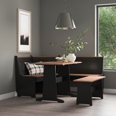 a corner table with two benches in front of a window