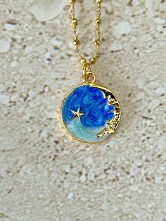 Celestial pendant features a blue and turquoise enamel gold plated moon and stars pendant measuring 22 x 24mm accented with a gold pyrite rosary chain and lobster claw clasp. GIFT BOXED Blue Moon Shaped Necklace For Gift, Blue Star Shaped Necklace For Gift, Blue Moon Necklace For Gift, Blue Moon Phase Necklace For Gift, Blue Moon Phase Round Pendant Necklace, Blue Pendant Necklace With Star Charm, Blue Enamel Jewelry With Adjustable Chain, Blue Necklace With Star Charm As A Gift, Blue Celestial Necklace With Moon Charm