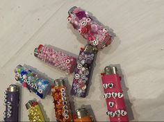 there are many different types of lighters on the table with candy wrappers around them