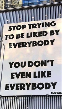 a sign on the side of a building that says stop trying to be liked by everybody you don't even like everybody