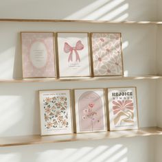 three wooden shelves with greeting cards on them and one has a pink bow in the middle