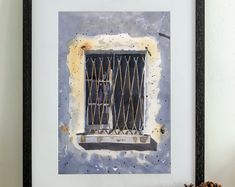 a painting of a window with bars on the side and a pine cone next to it