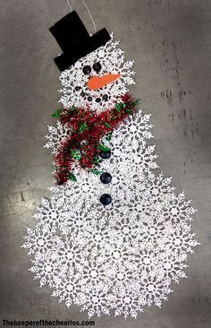 a snowman made out of paper on the ground