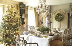 a dining room with a christmas tree and table set for two, surrounded by holiday decorations