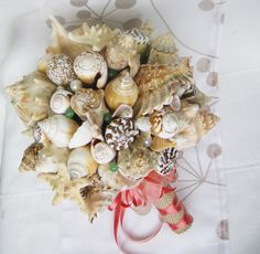 "These beautifully hand-crafted sea shell bouquets with semiprecious stones green Aventurin (A semi-precious stone that is said to be the luckiest of all crystals, especially in manifesting prosperity and wealth, or for increasing favor in competitions or games of chance. Its winning energy makes it a great ally for boosting one's chances in any situation) are perfect for all \"Beach Brides\"! These bouquets are a beautiful piece to add to your wedding day. After your special day has come to an Shell Bouquet, Wedding Nautical, Wedding Coastal, Manifesting Prosperity, Bouquet Bridal, Beach Bride, Coastal Wedding, Nautical Wedding, Bridesmaid Bouquet