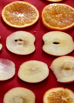 sliced up oranges sitting on top of a red table