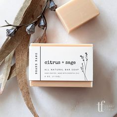 a bar of soap sitting on top of a white surface next to some dried leaves