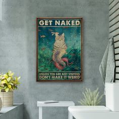 a bathroom with a toilet and a poster on the wall above it that says get naked unless you are just wishing don't make it weird