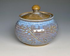 a blue and gold jar with a lid