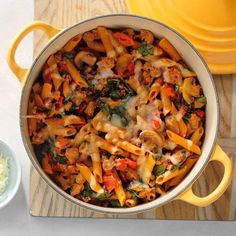 a yellow pot filled with pasta and vegetables