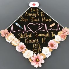 a decorated graduation cap with flowers and a nurse's stethoscope on it