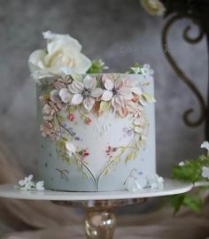 there is a white cake with flowers on it