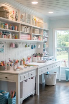 a room with lots of crafting supplies on the shelves and desks in it