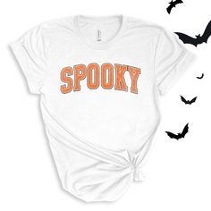 Spooky graphic in a varsity orange and white font. Perfect for this spooky season! Wear to school dress up days, Halloween parties, or just around town for halloween spirit! For All Varsity Spooky T-shirts click here to view.For Adult & Youth Varsity Spooky Sweatshirts click here to view. Adult Sizes S-XXL (unisex sizing)Youth Sizes S-XL (unisex sizing)Toddler Sizes 2T, 3T, 4T (unisex sizing) Bella + Canvas (Adult, Youth & Toddler)4.2 oz. Airlume combed and ring-spun cottonPre-shrunkFor a more relaxed fit, size up! Spooky Orange T-shirt For Fall, Trendy Fall T-shirt For School, Orange Halloween T-shirt With Letter Print, Trendy Halloween Text Print T-shirt, College Fall T-shirt With School Spirit, White T-shirt For Game Day In Fall, White Varsity T-shirt For Fall, Halloween Slogan T-shirt For Streetwear, College Letter Print T-shirt For Fall