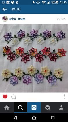 several different colored crocheted flowers on a white cloth