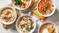 four bowls of oatmeal with fruit, nuts and yogurt