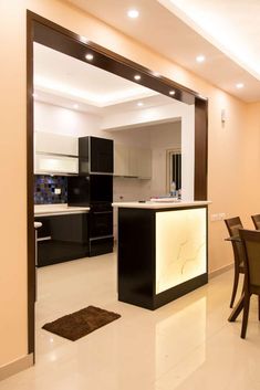 an open kitchen and dining room area in a modern style home with white tile flooring