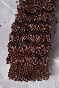 a piece of chocolate cake sitting on top of a white napkin