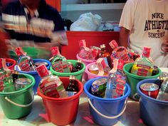 several buckets filled with drinks sitting on top of a table